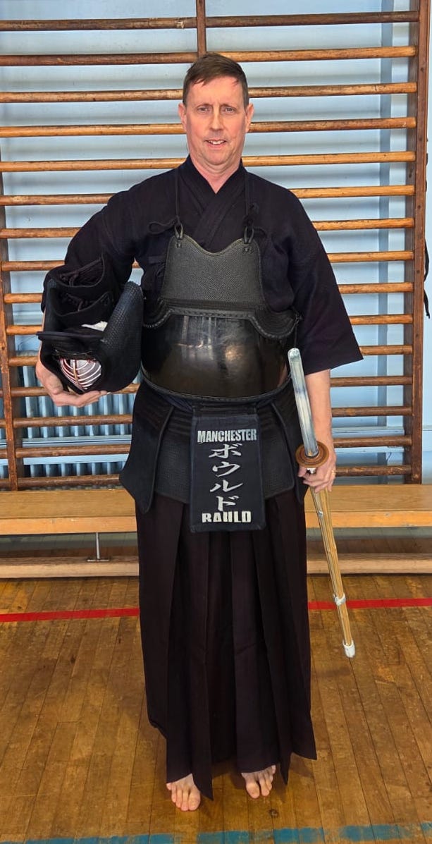 Ewan Bauld in kendo clothing, holding his men and shinai